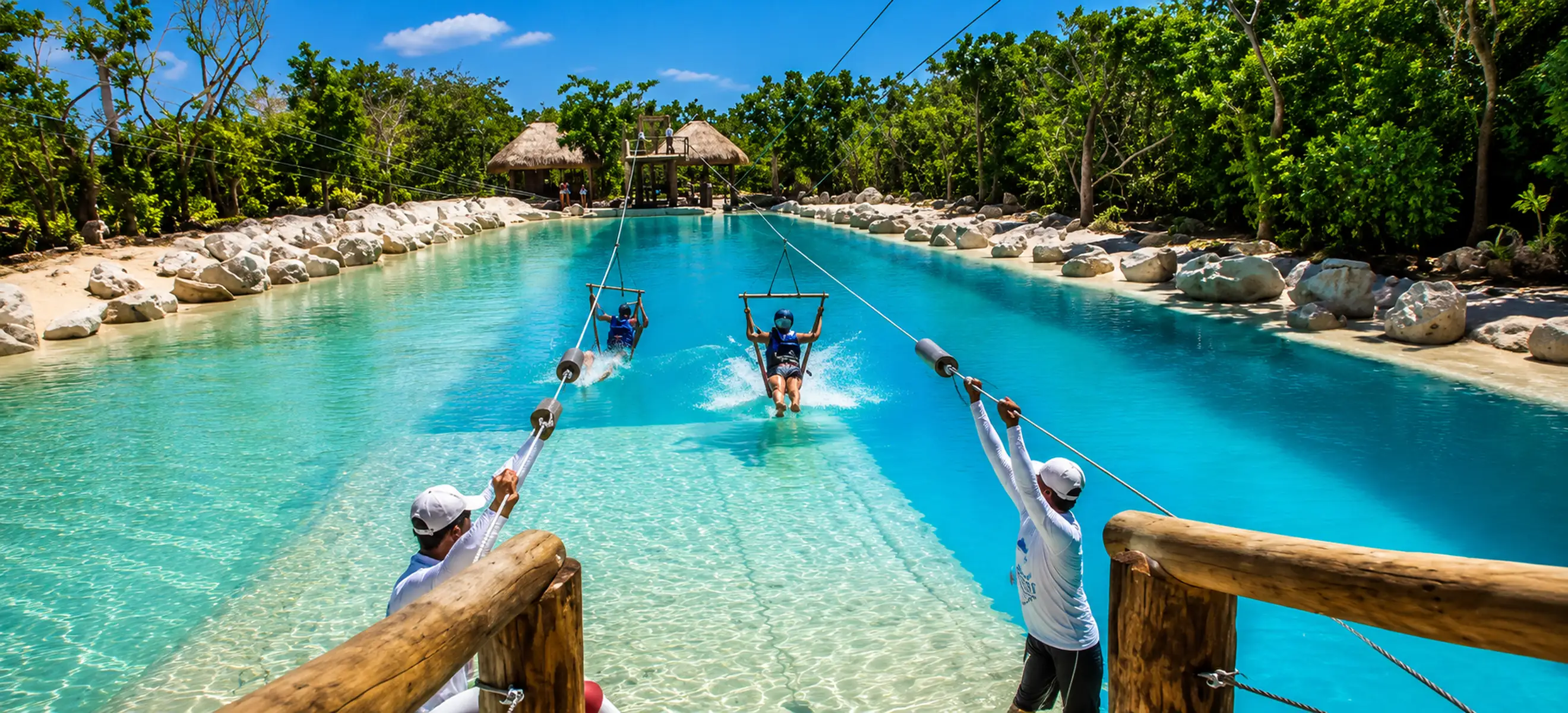Guests enjoying the Saltos Azules water zipline attraction at Scape Park Cap Cana, featuring crystal-clear turquoise lagoons and tropical scenery in Punta Cana, Dominican Republic.