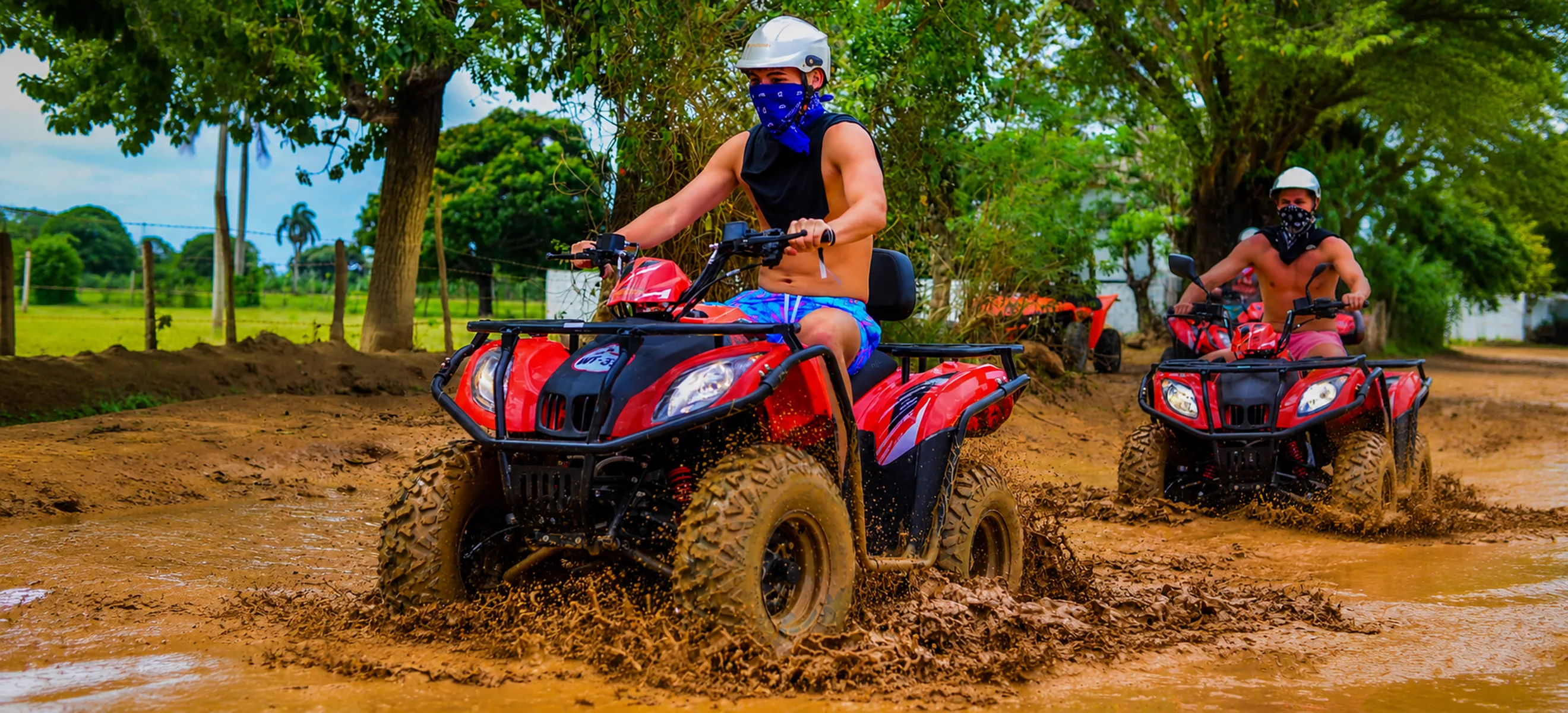 Wild Trails Buggies convoy driving through muddy off-road trails during an exciting adventure tour in Punta Cana, Dominican Republic.