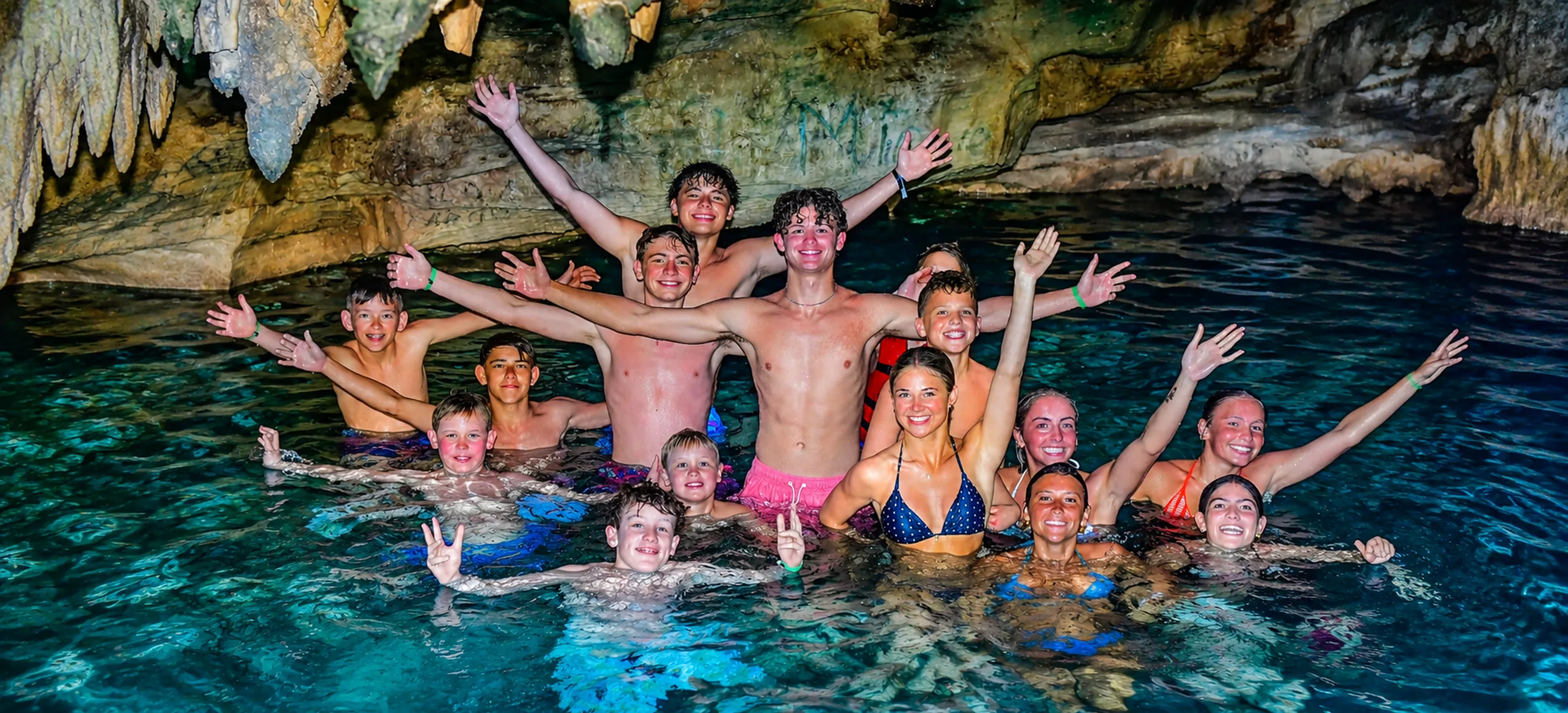 Guests enjoying a refreshing swim inside a natural freshwater cave during the Wild Trails Buggies adventure in Punta Cana, Dominican Republic.